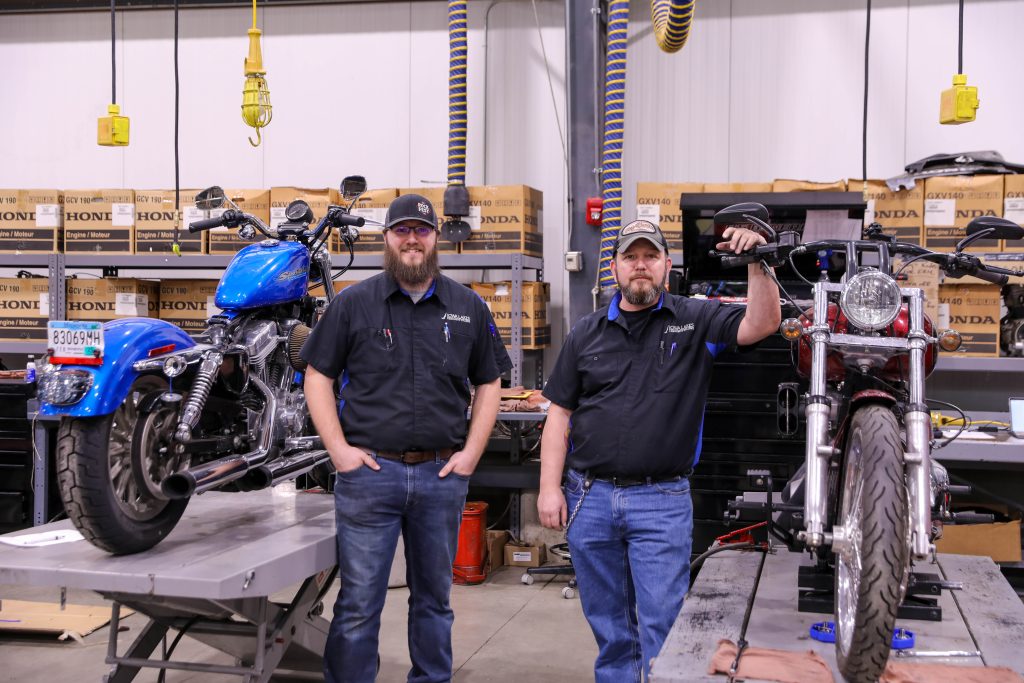 Powersports father and son duo in shop
