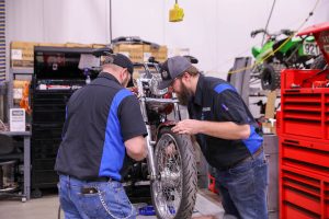 Father and son working on motorcycle