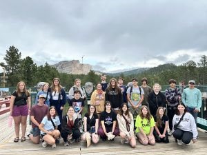 Trio students in front of Mount Rushmore