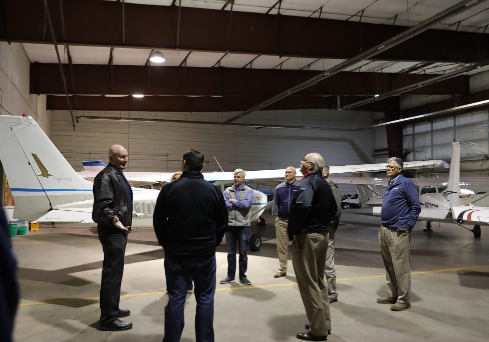 Legislators and staff in Airplane Hangar