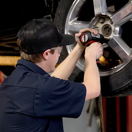 Auto tech changing tire