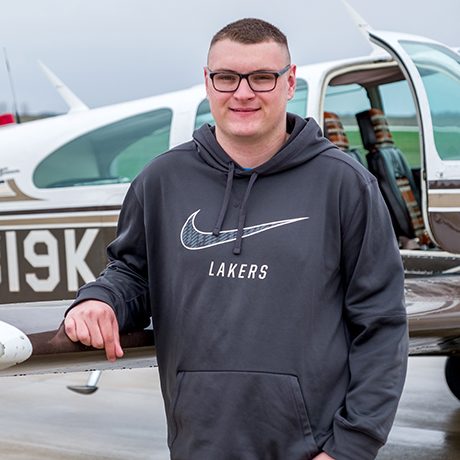 Aviation student in front of airplane