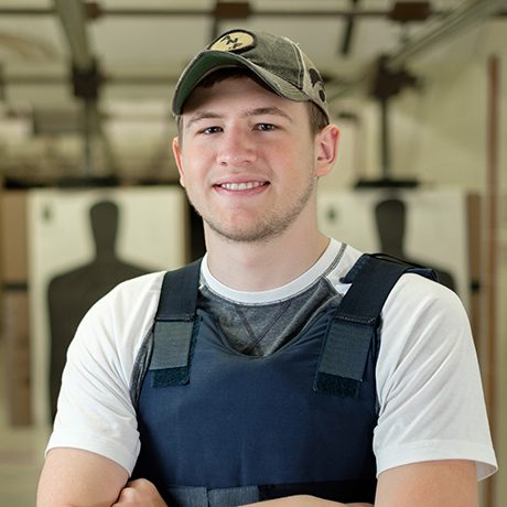 Criminal justice student wearing a bullet proof vest in a shooting range