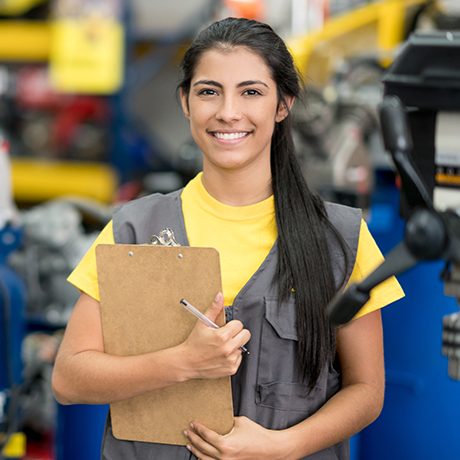 Portrait of a happy Latin American woman working at a hardware store and looking at the camera smiling